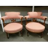 A pair of Edwardian inlaid Rosewood tub chairs on turned front legs