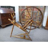 An antique spinning wheel, engraved initials P.J.S