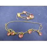 Victorian yellow coloured metal necklace hung with five pale pink oval cabouchon stone pendants,