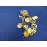 Heavy 9ct yellow gold charm bracelet hung with various 9ct yellow gold charms including St