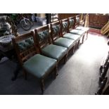 A set of six late Victorian oak dining chairs having button back on turned front legs.