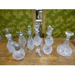 Three silver plated jugs and a quantity of glass decanters