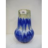 A Ruskin pottery vase with blue drip decoration, stamped to base and date stamp 1932, 22 cms