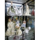 Two shelves of figurines by Royal Doulton, Royal Worcester and others