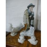 A German porcelain figure of man with dog and three Lladro items