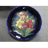 Moorcroft; a large blue bowl decorated flowers 31.5cms,