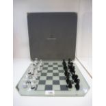A Swarovski silver crystal chess set and mirrored board in fitted case