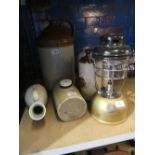 A quantity of earthenware bottles and flagons etc together with an original tilly lamp