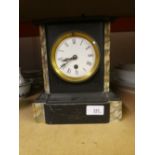 A slate mantle clock with key and pendulum