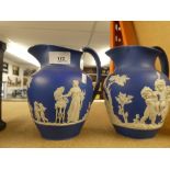 A pair of blue & white jugs A/F