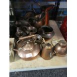 A quantity of brass measuring jugs together with cutlery and a box of similar.