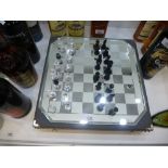 A Swarovski silver crystal chess set and mirrored board in fitted case