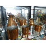 Four antique copper measuring mugs and two jugs