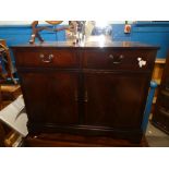 A vintage sideboard with two drawers above cupboards