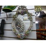 Ceramic wall mirror with flower decoration