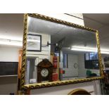 Gilt framed bevelled glass wall mirror, with an oval example