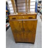 A mahogany tall boy with drawer above cupboards, with fitted interior on bracket feet