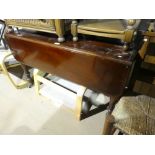 Victorian Mahogany drop flap table on turned supports & casters