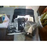 A large black portfolio case with large black and white photographs