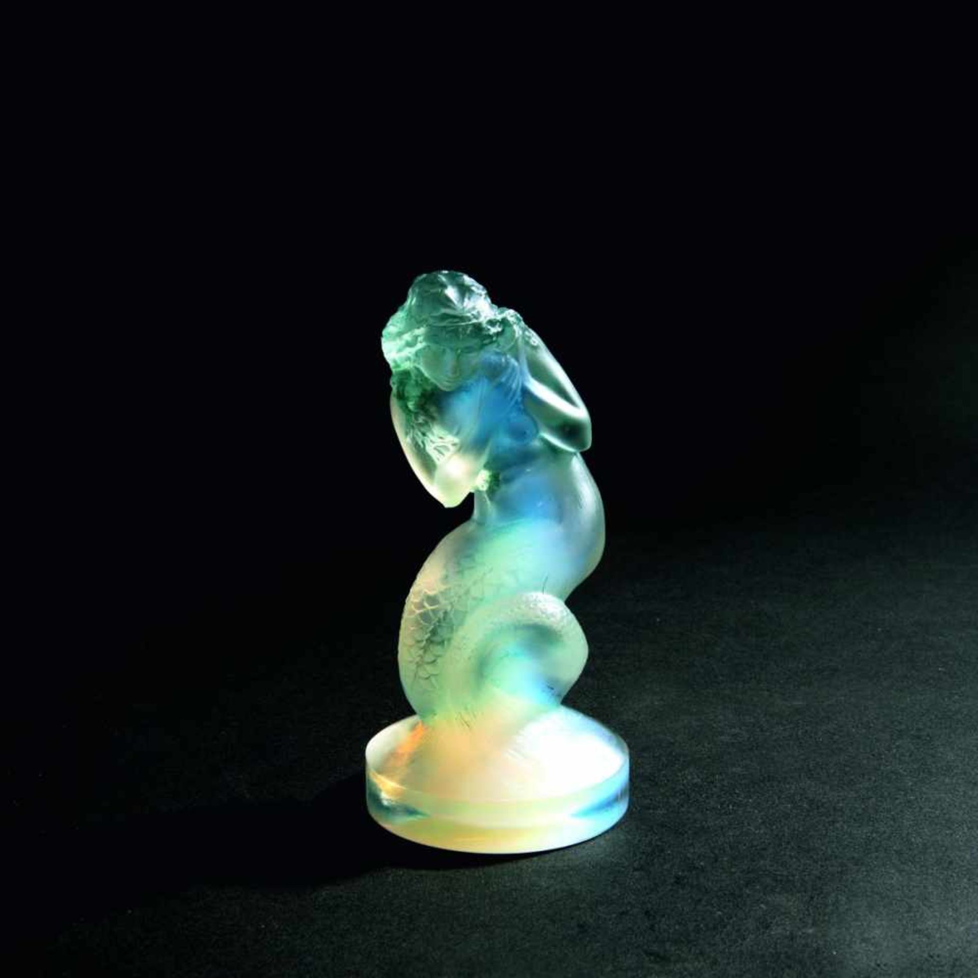 René Lalique, 'Naiade' figurine, 1920'Naiade' figurine, 1920H. 13.5 cm. Clear moulded glass, blue