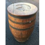 A nineteenth century oak herring barrel, the staives bound by iron strap bands, having hinged lid
