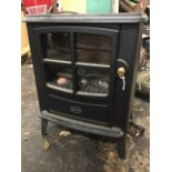A Dimplex electric stove with glowing faux coals behind door.