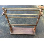 A Victorian mahogany towel stand with five rails on ring-turned columns above a rectangular