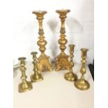 A pair of large moulded candlesticks on triangular scrolled bases with paw feet; and two pairs of