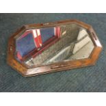 A George VI octagonal oak framed mirror, the bevelled plate in beaded frame with applied split
