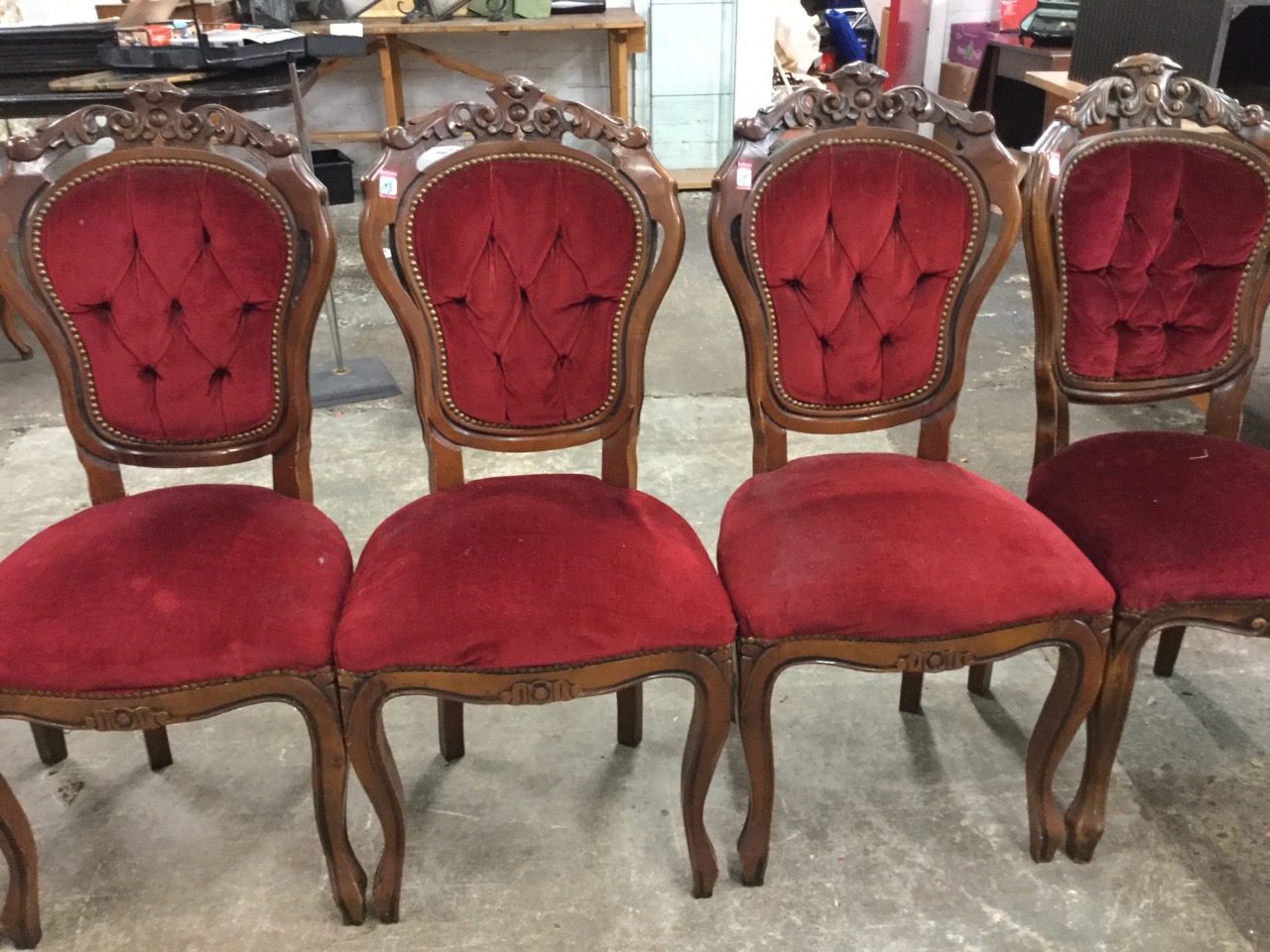 A set of seven carved Louis XV style dining chairs with pierced crests above button upholstered