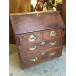 A small eighteenth century oak bureau, the fallfront enclosing a baize lined interior with drawers