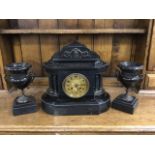 A Victorian polished slate mantleclock garniture, the architectural style case with fluted columns