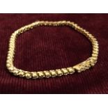 An 18ct yellow gold diamond tennis bracelet, the claw set diamonds weighing two and a half carats,