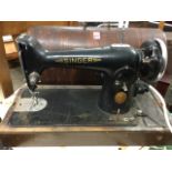 An oak cased Singer sewing machine with domed box, wired with modern 13amp plug.