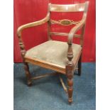 A nineteenth century mahogany elbow chair, the back rail with panel framed by ebony stringing
