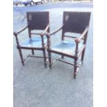 A pair of nineteenth century leather upholstered walnut armchairs, having brass studded panels and