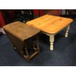 A square pine coffee table on turned painted legs; and a drop-leaf oak coffee table supported on