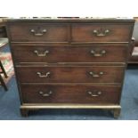 A George III mahogany chest of two short and three long cockbeaded drawers mounted with brass swan-