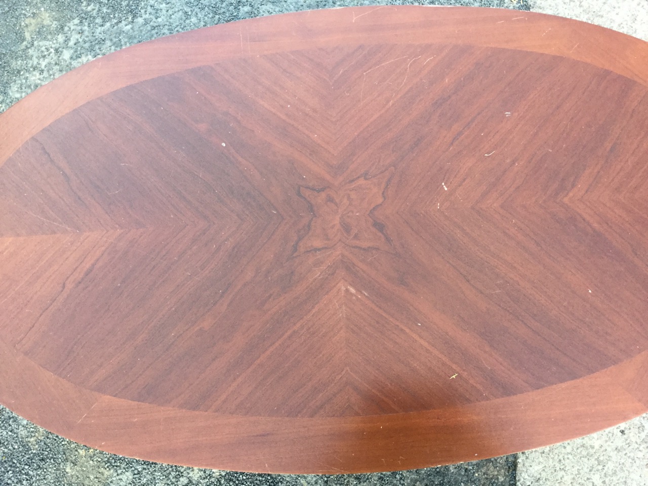 An oval mahogany coffee table, the crossbanded quarter veneered top on bulbous turned column, raised - Image 2 of 3