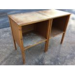 A pair of hutch style storage tables with open compartments on rectangular pine legs. (2)