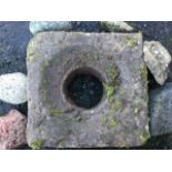 A square carved sandstone drain basin with central circular aperture; together with six