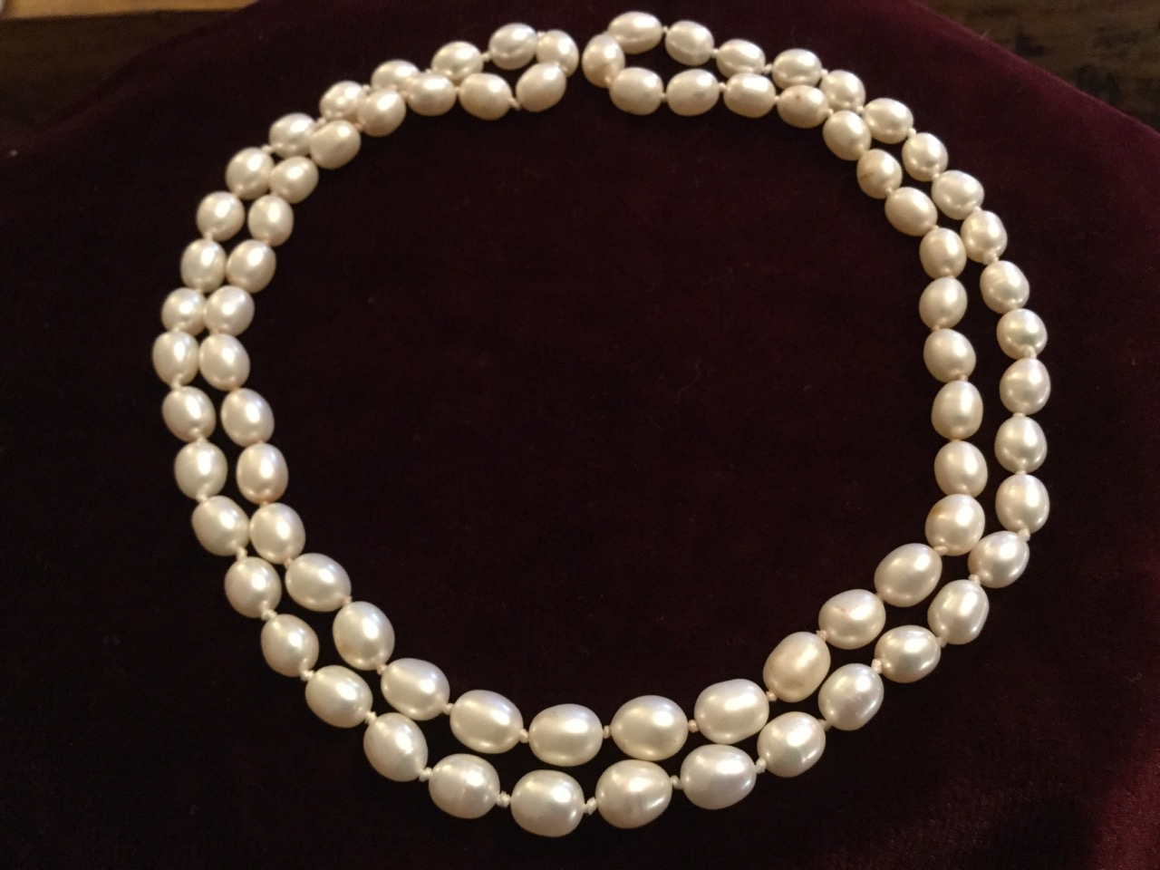 A pearl necklace, with seventy seven individually knotted freshwater pearls. (16in)