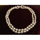 A pearl necklace, with seventy seven individually knotted freshwater pearls. (16in)