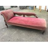 A Victorian chaise longue, the upholstered back rail above pierced lattice carved panels, the