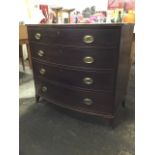 A nineteenth century bowfronted mahogany chest of drawers with four graduated cockbeaded drawers