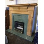 A pine chimneypiece, the surround with moulded breakfront mantelpiece above a fluted frieze, the