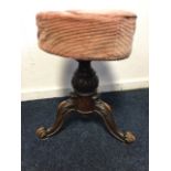 A Victorian rise & fall stool with circular upholstered seat telescopically rising on turned