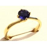 An 18ct yellow gold sapphire ring, the circular claw set sapphire weighing one carat, raised and