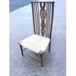 A Liberty & Co rush seated side chair, with yoke back rail above wheel pierced splat framed by