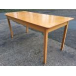 A rectangular work table, the top with one corner cut supported on square pine column legs. (82.